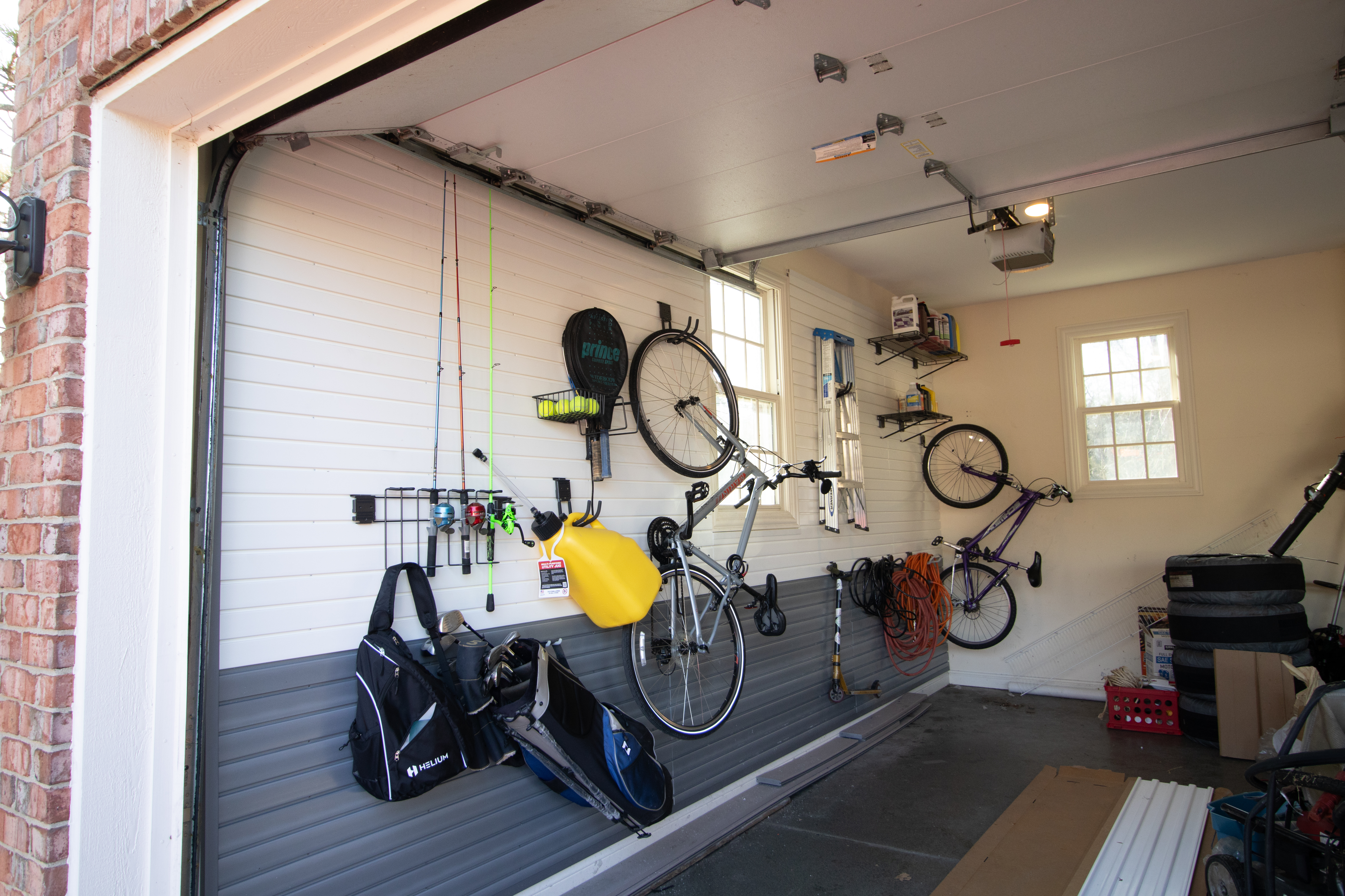 HandiWall garage slatwall system organized with hooks and bins